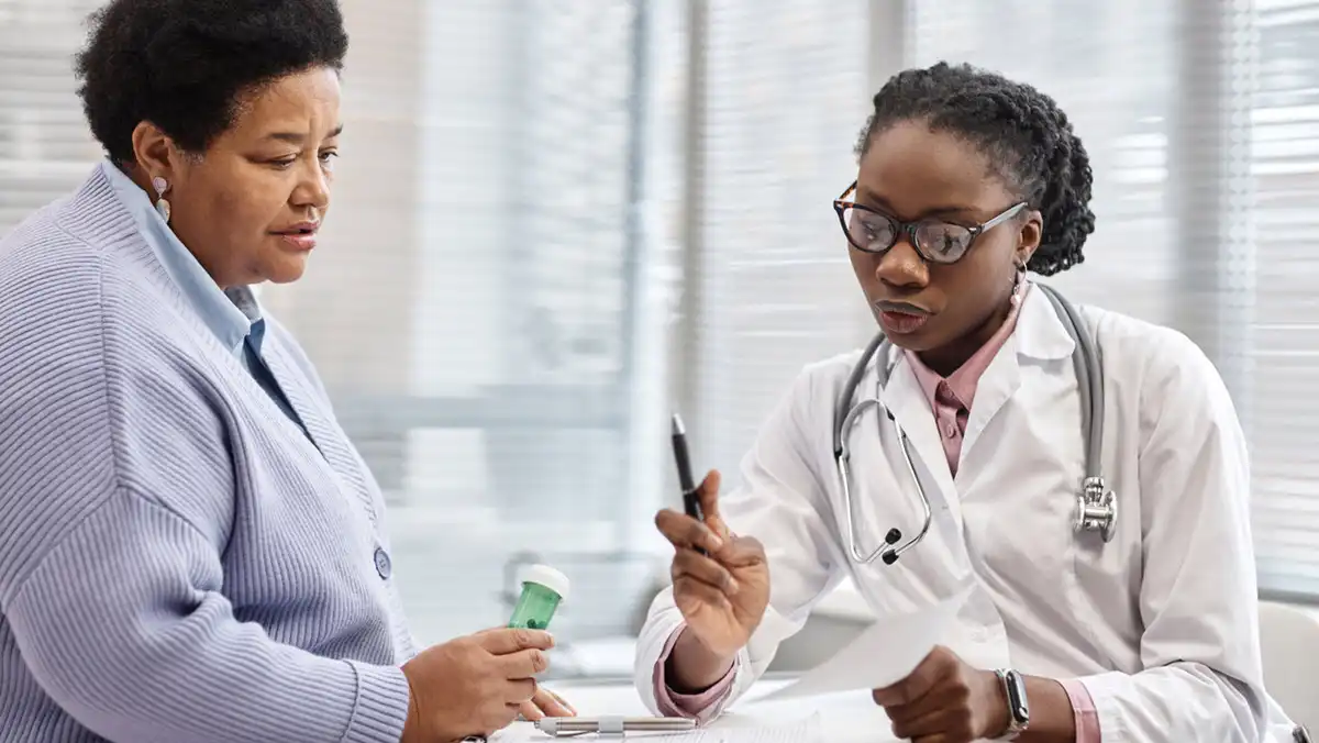 Health care provider reviews treatment with patient